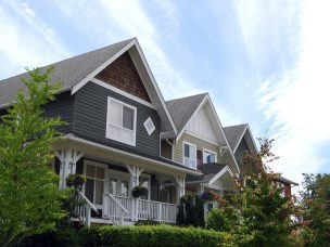 Partial view of new homes in a suburban neighbourhood on a sunny day.  See also